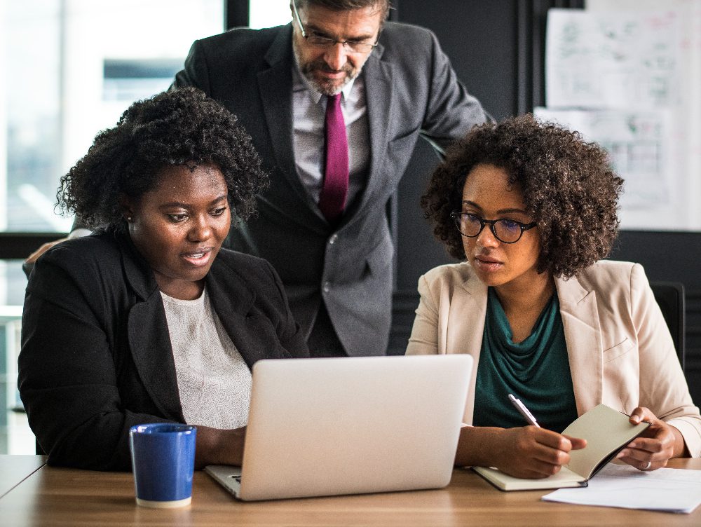 Empower the Next Generation of Leader (2) Multiracial analyst team use BI Fintech software to analyze financial data on meeting table. Financial dashboard data display on laptop screen with analyzed chart for marketing indication.