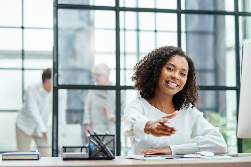 smiling business woman pointing at you.